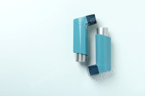 Preview: Blue asthma inhalers on white background, top view