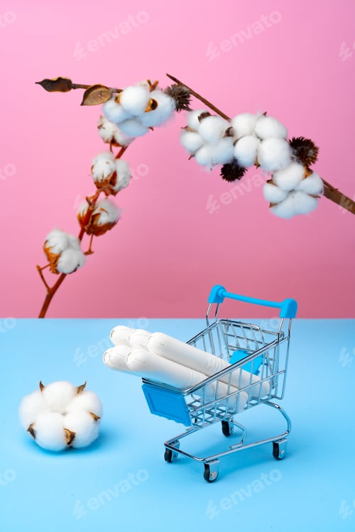 Preview: Shopping cart with medical tampons on pink and blue background