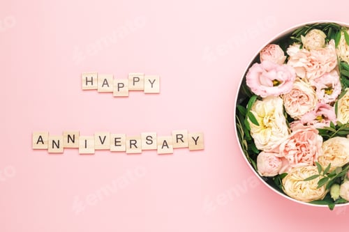 Preview: Happy anniversary lettering on the wooden squares with letters on the pink background and big round