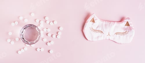 Preview: Good sleep concept, sleeping pills, glass of water and sleep mask on pink top view web banner