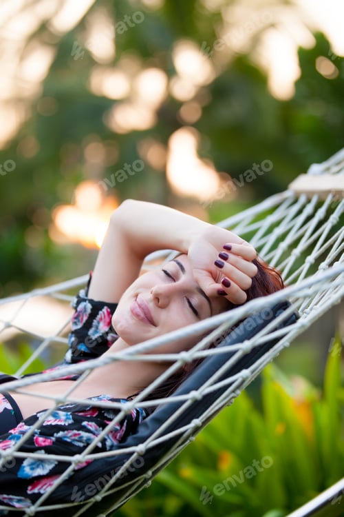 Preview: woman relaxing in a hammock