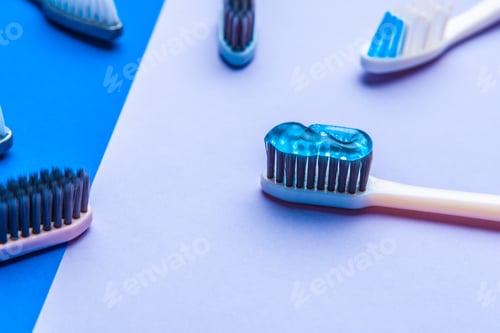 Preview: Flat lay composition with manual toothbrushes on color background, close up