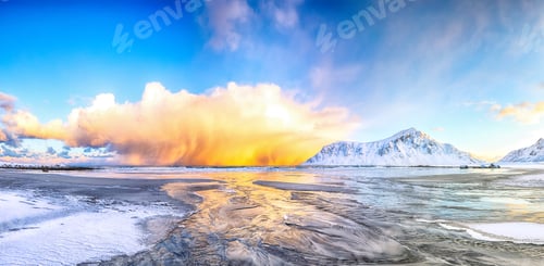 Preview: Outstanding winter scenery on Skagsanden beach with illuminated clouds during sunrise.
