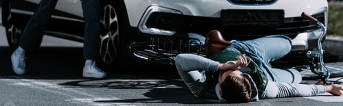 Preview: cropped shot of woman running to injured cyclist at car accident