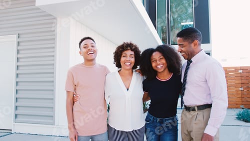 Preview: Portrait Of Smiling Family With Older Children Standing In Front Of House