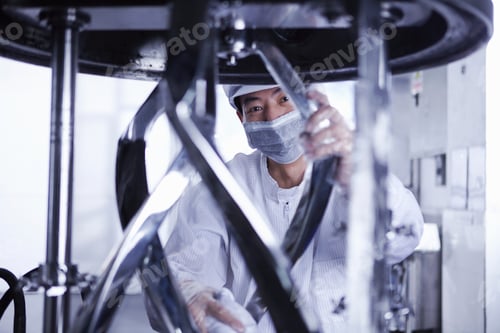 Preview: Worker at e-cigarettes battery factory, Guangdong, China