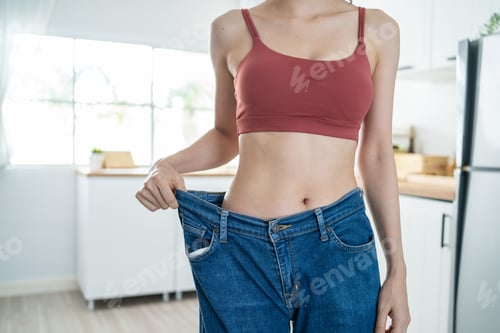 Preview: Close up of woman feel happy after lose weight for health in house.