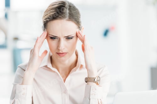 Preview: portrait of tired pensive businesswoman with hands on head looking down