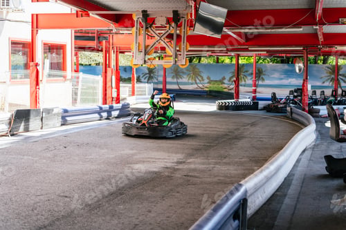 Preview: Child celebrating go kart racing victory on track