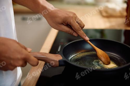 Preview: Close up of black man making a breakfast at home.