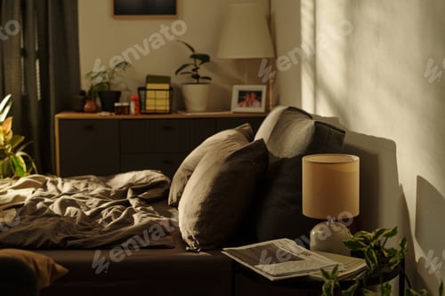Preview: Empty Unmade Bed in Sunlit Room Suggesting Family Conflict