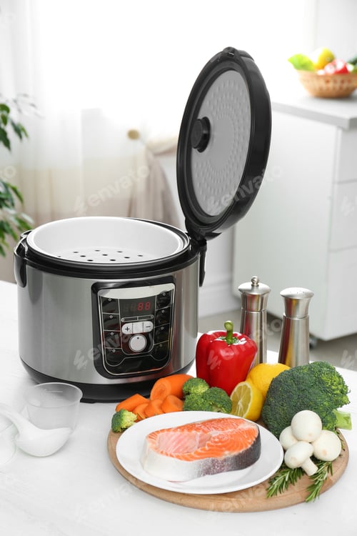 Preview: Modern multi cooker and products on kitchen table