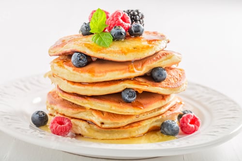 Preview: Closeup of american pancakes with berries on white background