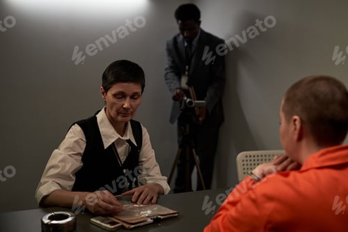 Preview: Middle Aged Caucasian Woman Interrogating Young Adult Caucasian Woman in Prison