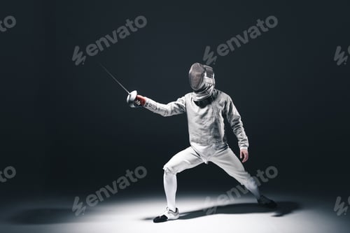 Preview: Professional fencer in fencing mask with rapier standing in position isolated on grey