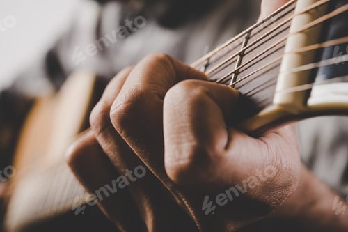 Preview: Close up of man hand playing guitar.