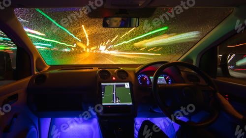 Preview: The man drive car in the rainy city. Left side traffic. Evening night time