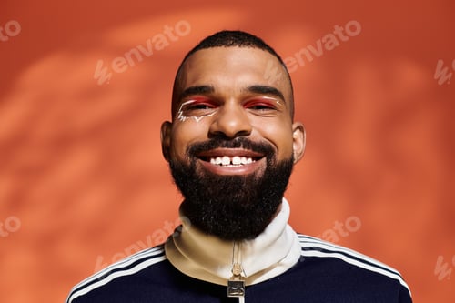 Preview: Stylish young man with a captivating smile enjoying a vibrant fashion moment indoors
