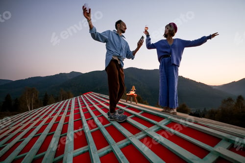 Preview: Man and woman enjoy beautiful sunset in the mountains
