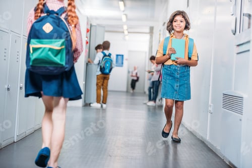 Preview: beautiful little kids walking through school corridor