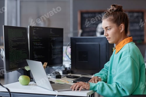 Preview: Developer working on computers in office