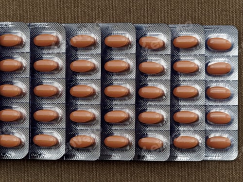 Preview: brown pills to support human health in plastic package