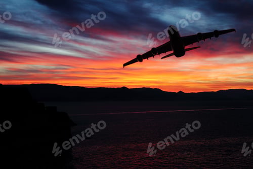 Preview: Scenic view of sunrise over the mountains with airplane over the sea