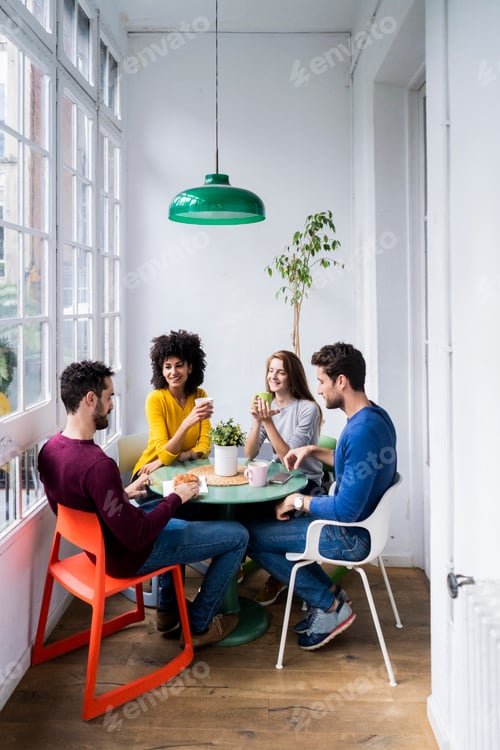 Preview: Four friends at home having coffee break