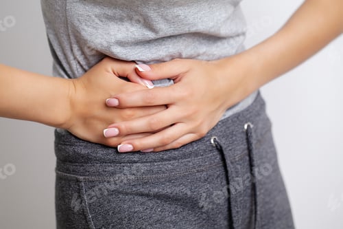 Preview: Woman feels pain in the abdomen, holding the place of pain with her hands