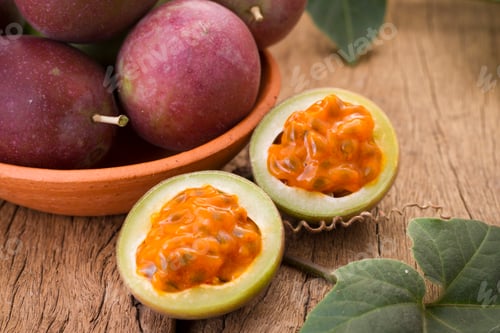 Preview: fruits of gulupa on vine wood table, Passiflora pinnatistipula