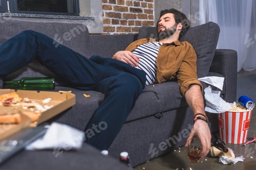 Preview: loner sleeping on sofa with glass of whiskey in dirty living room