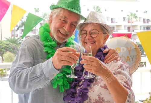 Preview: Joyful elderly couple celebrates a birthday in a festive and colorful setting Wearing party hats