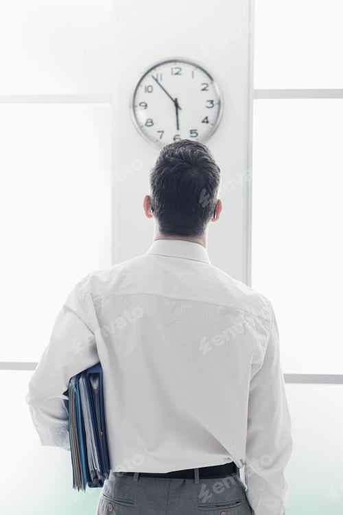 Preview: Businessman staring at the clock