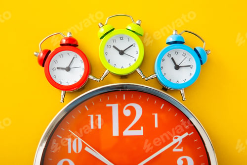 Preview: Alarm clock on yellow background.