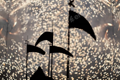 Preview: silhouette of a scythe and fireworks in the background. selective focus out-of-focus background