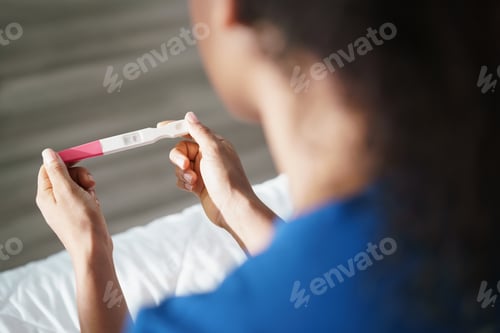 Preview: Woman Holding Negative Pregnancy Test Kit
