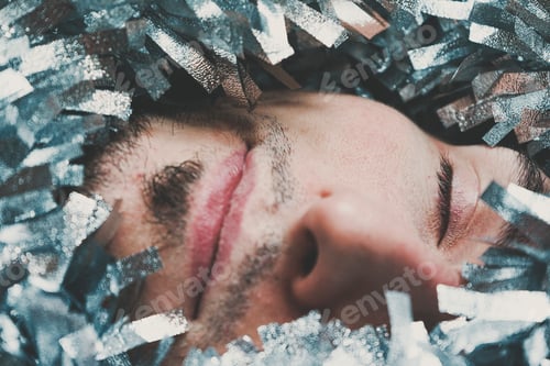 Preview: Young male surrounded by silver garland at christmas