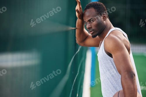 Preview: Handsome black man is posing outdoors at daytime