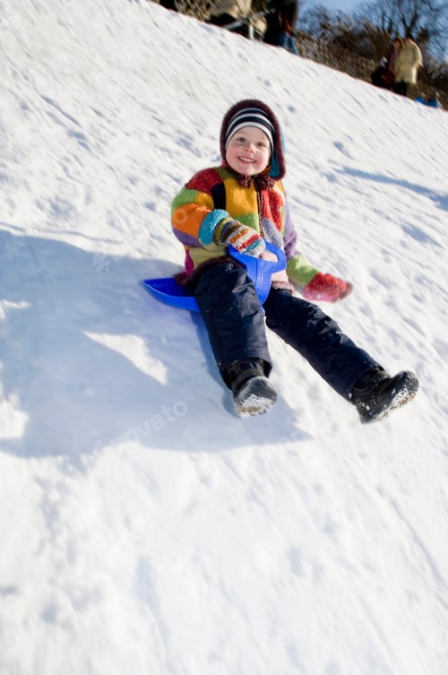 Preview: boy riding a sledge in snow