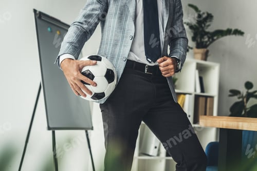 Preview: cropped shot of businessman with soccer ball at workplace