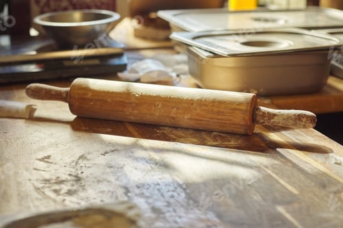 Preview: Wooden table in the kitchen with flour, rolling pin dough, nobody