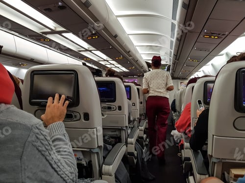 Preview: People in passenger jet using multimedia entertainment system.