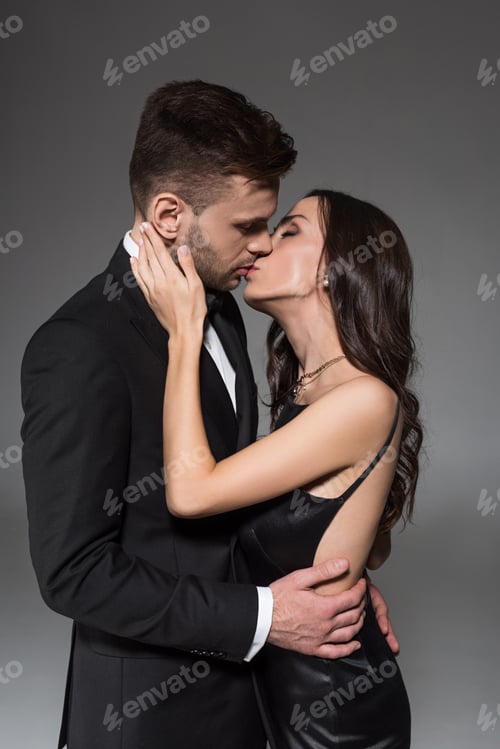 Preview: attractive elegant couple kissing and embracing isolated on grey