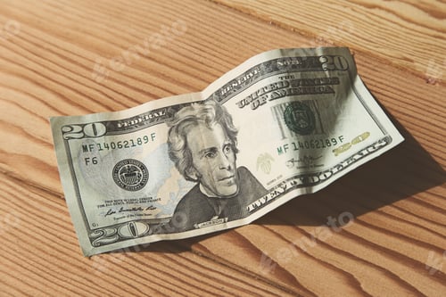 Preview: High angle shot of an American dollar bill on a wooden surface