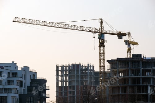 Preview: Tower cranes and high residential apartment buildings under construction. Real estate development.