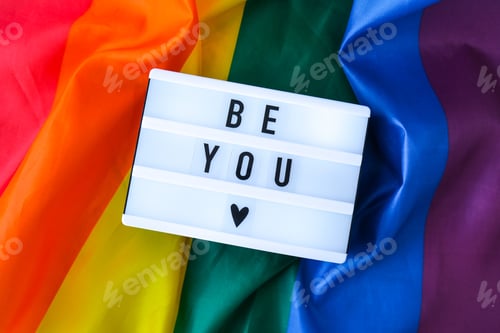 Preview: Rainbow flag with lightbox and text BE YOU. Rainbow lgbtq flag made from silk material. Symbol of LG