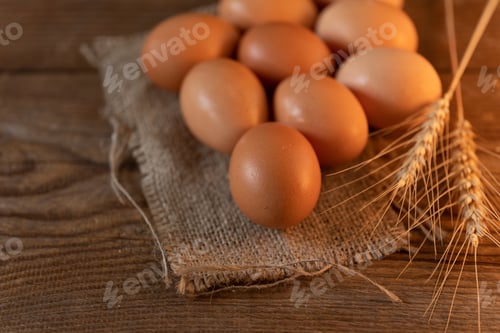 Preview: Brown eggs on a burlap on an old wooden table
