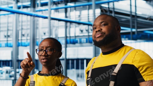 Preview: Smart factory coworkers talking, working together to test automated systems