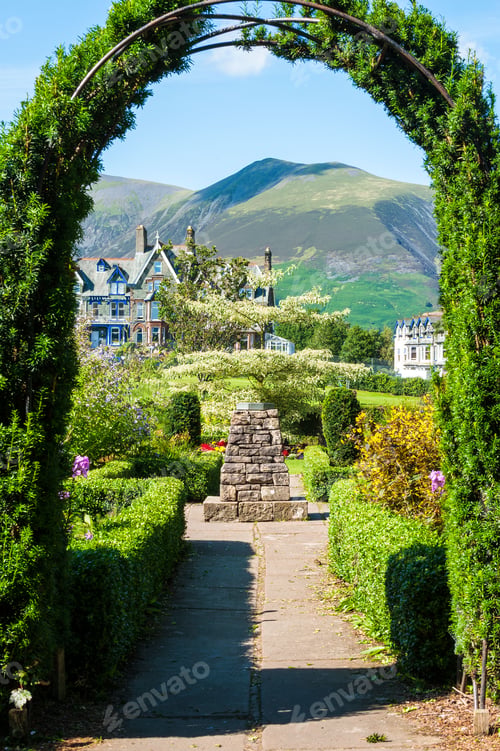 Preview: Vertical shot of Skiddaw framed by the arch in Hope Park gardens, Keswick, Cumbria