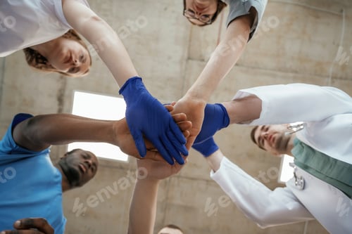 Preview: Celebrating success, hands gestures. View from below of group of doctors